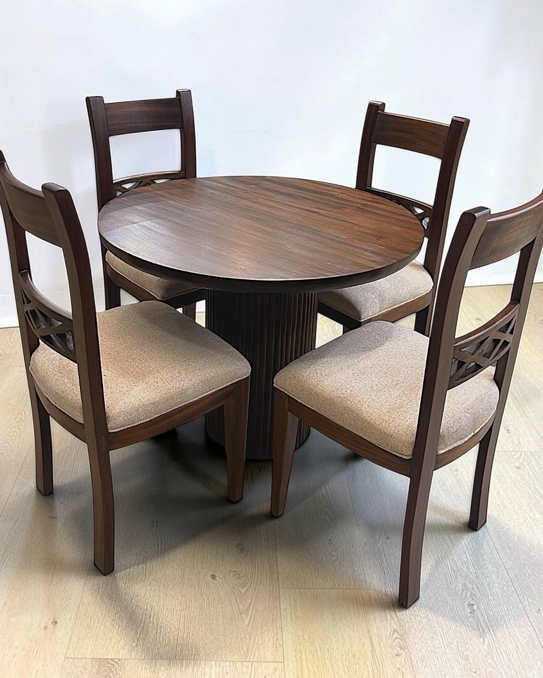 Round wooden dining set with four chairs